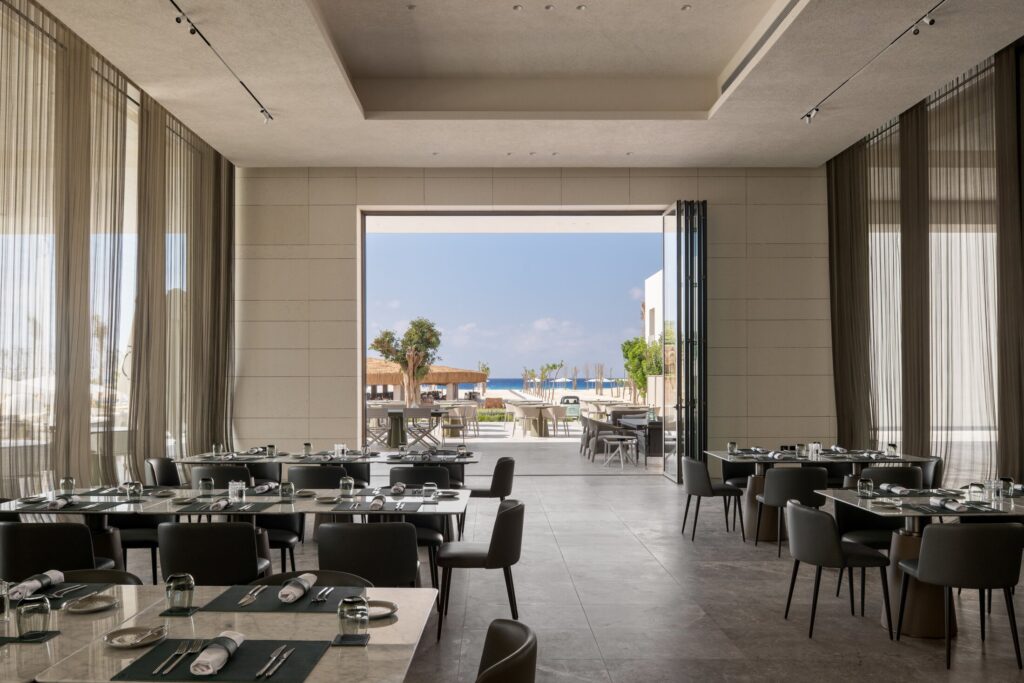 Dine indoors in chic, airy surroundings or step out to the terrace, where the gentle sea breeze enhances every bite.